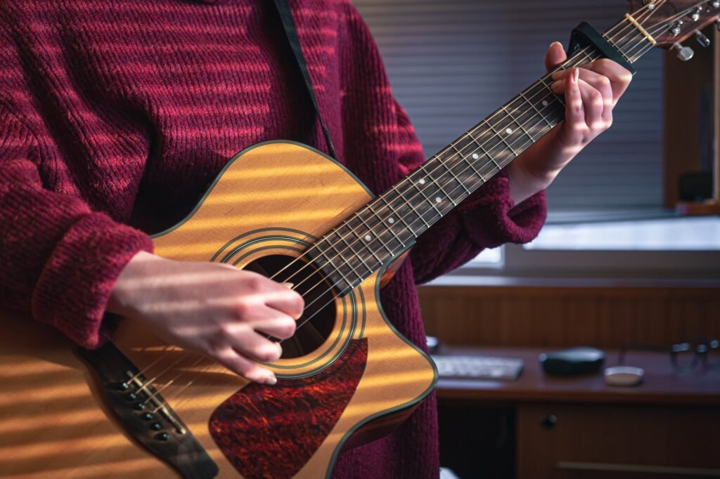 girl-with-a-guitar-in-the-sunlight-through-the-blinds-