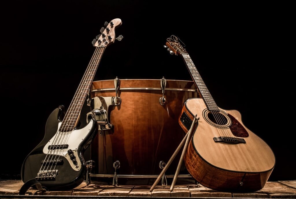 musical-instruments-bass-drum-barrel-acoustic-guitar-and-bass-guitar-on-a-black-background